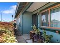 Inviting front porch with a small table, potted plants, and decorative details near the front door at 3207 W Michigan Ave, Phoenix, AZ 85053