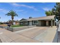 Well-maintained single-story home featuring covered parking, charming curb appeal, and tidy, modern landscaping at 3825 E Captain Dreyfus Ave, Phoenix, AZ 85032