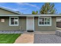 Inviting front entrance with a secure screen door, stone walkway, and freshly maintained landscaping at 3825 E Captain Dreyfus Ave, Phoenix, AZ 85032