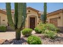 Stunning front entrance with native desert landscaping and a welcoming front door at 41903 N Golf Crest Rd, Anthem, AZ 85086