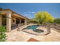 Backyard oasis features a fenced pool and spa, perfect for relaxing and entertaining at 41903 N Golf Crest Rd, Anthem, AZ 85086