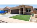 Charming single-story home featuring a desert landscape, brown garage door, and tiled roof at 41903 W Rojo St, Maricopa, AZ 85138