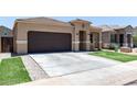Charming single-story home featuring a desert landscape, brown garage door, and tiled roof at 41903 W Rojo St, Maricopa, AZ 85138