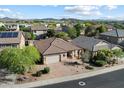 Residential neighborhood with houses, green trees, and beautiful mountain views in the background at 4413 W Phalen Dr, New River, AZ 85087