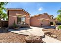 Beautiful, single-story home with a two car garage, landscaped yard, and a lovely stone accent wall at 4662 S Calico Rd, Gilbert, AZ 85297