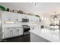 Bright kitchen features white cabinets and stainless steel appliances at 4662 S Calico Rd, Gilbert, AZ 85297