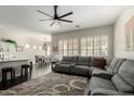 Open-concept living room with a gray sectional sofa and hardwood flooring at 4662 S Calico Rd, Gilbert, AZ 85297