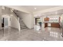 Spacious living room featuring tile flooring, a staircase, and an open floorplan at 6118 S 46Th Ave, Laveen, AZ 85339