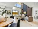Bright living room with fireplace, large windows, modern chandelier, and stylish decor at 6525 E Cave Creek Rd # 101, Cave Creek, AZ 85331