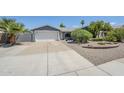 Charming home with a desert landscape, an attached two car garage, and a long driveway at 696 W Mesquite St, Chandler, AZ 85225