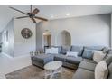 Bright and airy living room features vaulted ceilings, a large sectional sofa, and a decorative ceiling fan at 696 W Mesquite St, Chandler, AZ 85225
