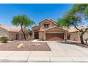 Inviting two-story home with desert landscaping and a two-car garage at 728 E Windsor Dr, Gilbert, AZ 85296