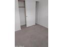 An empty walk in closet off of a bedroom features carpeted floors and a sliding door at 7284 E Gamebird Way, San Tan Valley, AZ 85143