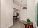 Entryway featuring tile floors with the front door in view and views into the office space at 8569 W Fullam St, Peoria, AZ 85382