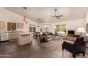Open-concept living room featuring tile flooring, neutral tones, and sliding glass doors to backyard at 8569 W Fullam St, Peoria, AZ 85382