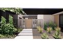 Striking front yard with contemporary design, featuring unique brickwork, desert plants, and modern pathway at 8618 E Irish Hunter Trl, Scottsdale, AZ 85258