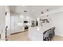 Bright kitchen with white cabinets, marble countertops, stainless appliances, and stylish pendant lighting at 9028 E Altadena Ave, Scottsdale, AZ 85260