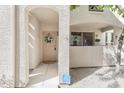 Charming entryway with covered porch, decorative wreath, and security system provides a warm welcome to the property at 9550 E Thunderbird Rd # 152, Scottsdale, AZ 85260