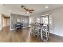 Open dining area with hardwood floors, stylish decor, and a large bay window at 1027 S Siesta Ln, Tempe, AZ 85281