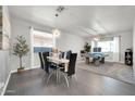 Dining room with a modern glass table and a billiards area illuminated by stylish lights at 10430 W Los Gatos Dr, Peoria, AZ 85383