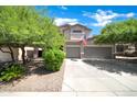 Beautiful two-story home with a three-car garage and well-maintained landscaping at 10430 W Los Gatos Dr, Peoria, AZ 85383