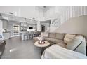 Open-concept living room with staircase and views of the adjacent kitchen at 10430 W Los Gatos Dr, Peoria, AZ 85383