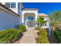 Inviting front entrance with modern doors and lush landscaping creates curb appeal at 11089 N 130Th Pl, Scottsdale, AZ 85259