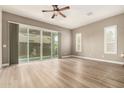 Light-filled living room with wood floors, large windows, and shutters for a blend of style and comfort at 1255 N Arizona Ave # 1300, Chandler, AZ 85225