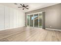 Bright living room boasts hardwood floors, sliding glass doors, and decorative accent wall for modern charm at 1255 N Arizona Ave # 1300, Chandler, AZ 85225
