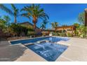 Backyard pool with an attached hot tub and covered patio, perfect for outdoor entertaining at 1474 E Locust Dr, Chandler, AZ 85286