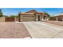 Single-story home showcasing a neutral color palette, long driveway, and well-maintained front yard at 1583 N Constellation Ct, Gilbert, AZ 85234