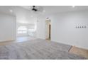 Open-concept living room featuring a light grey carpet, recessed lighting, and tile flooring at 1616 N 125Th Ln, Avondale, AZ 85392