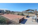 A community area features a horseshoe pit and benches next to the tennis courts at 17388 W Jessie Ln, Surprise, AZ 85387