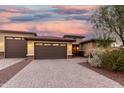 Charming home featuring a three-car garage and desert landscaping, enhancing its curb appeal at 18108 W Cassia Way, Goodyear, AZ 85338