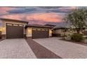 Lovely home with a three-car garage, block-paved driveway, and mature desert landscaping at 18108 W Cassia Way, Goodyear, AZ 85338
