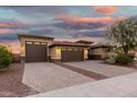 Lovely home with a three-car garage, block-paved driveway, and mature desert landscaping at 18108 W Cassia Way, Goodyear, AZ 85338