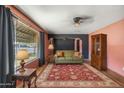 Inviting living room with plush sofa, decorative rug, and natural light from a large window at 2020 W Marshall Ave, Phoenix, AZ 85015