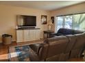 Relaxing living room with large tv and a plush leather reclining sofa at 211 Bahia E Ln, Litchfield Park, AZ 85340