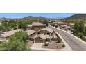 An aerial view shows the tan two-story home in a desert landscape at 2210 E Paraiso Dr, Phoenix, AZ 85024