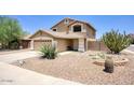 Tan two-story home boasts a desert landscaped front yard at 2210 E Paraiso Dr, Phoenix, AZ 85024