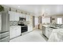 Bright kitchen features white cabinets, stainless appliances, and tile backsplash at 2210 E Paraiso Dr, Phoenix, AZ 85024