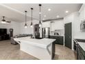 Open-concept kitchen featuring a large island, stainless steel appliances, and modern lighting at 278 S San Luis Rey Trl, Casa Grande, AZ 85194