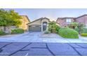 Single-story home with two car garage, desert landscaping, and wide driveway at 29384 N Rosewood Dr, San Tan Valley, AZ 85143