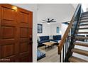 Inviting entryway with hardwood door, staircase, and view of the stylish living room at 2946 N 14Th St # 37, Phoenix, AZ 85014