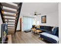 Bright living room with a comfy sofa, sleek floors, and a staircase in the background at 2946 N 14Th St # 37, Phoenix, AZ 85014