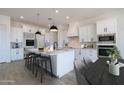 Modern kitchen with stainless steel appliances, quartz countertops, and a large island with seating at 29587 N 156Th St, Scottsdale, AZ 85262