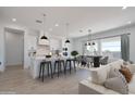 Open concept living featuring a stylish kitchen with white cabinets and a dining area at 29587 N 156Th St, Scottsdale, AZ 85262