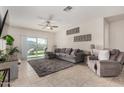 Bright living space with neutral tile, a comfortable sectional sofa, and access to outdoor patio at 3026 N 305Th Dr, Buckeye, AZ 85396