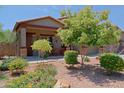 Charming single-story home featuring a well-manicured front yard with colorful desert landscaping at 4609 W Challenger Trl, New River, AZ 85087