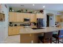 Eat-in kitchen featuring a large island, stainless appliances, and ample counter space at 4609 W Challenger Trl, New River, AZ 85087